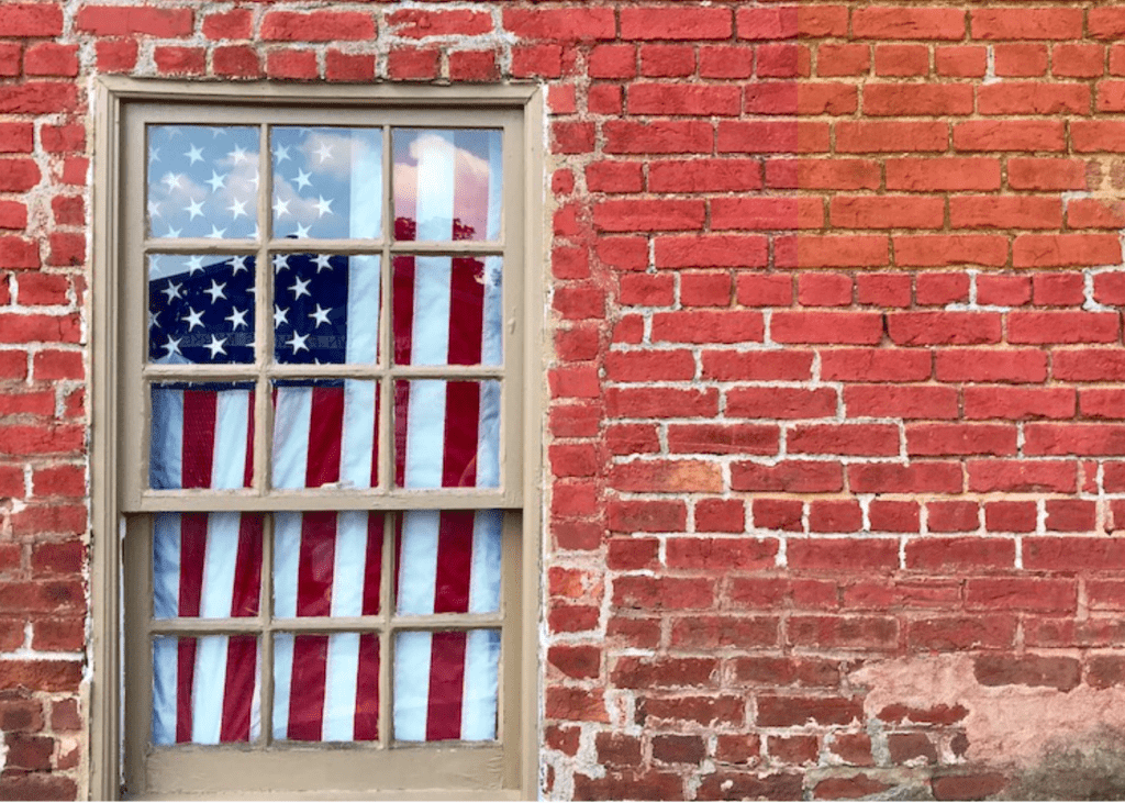 American flag hanging in a window