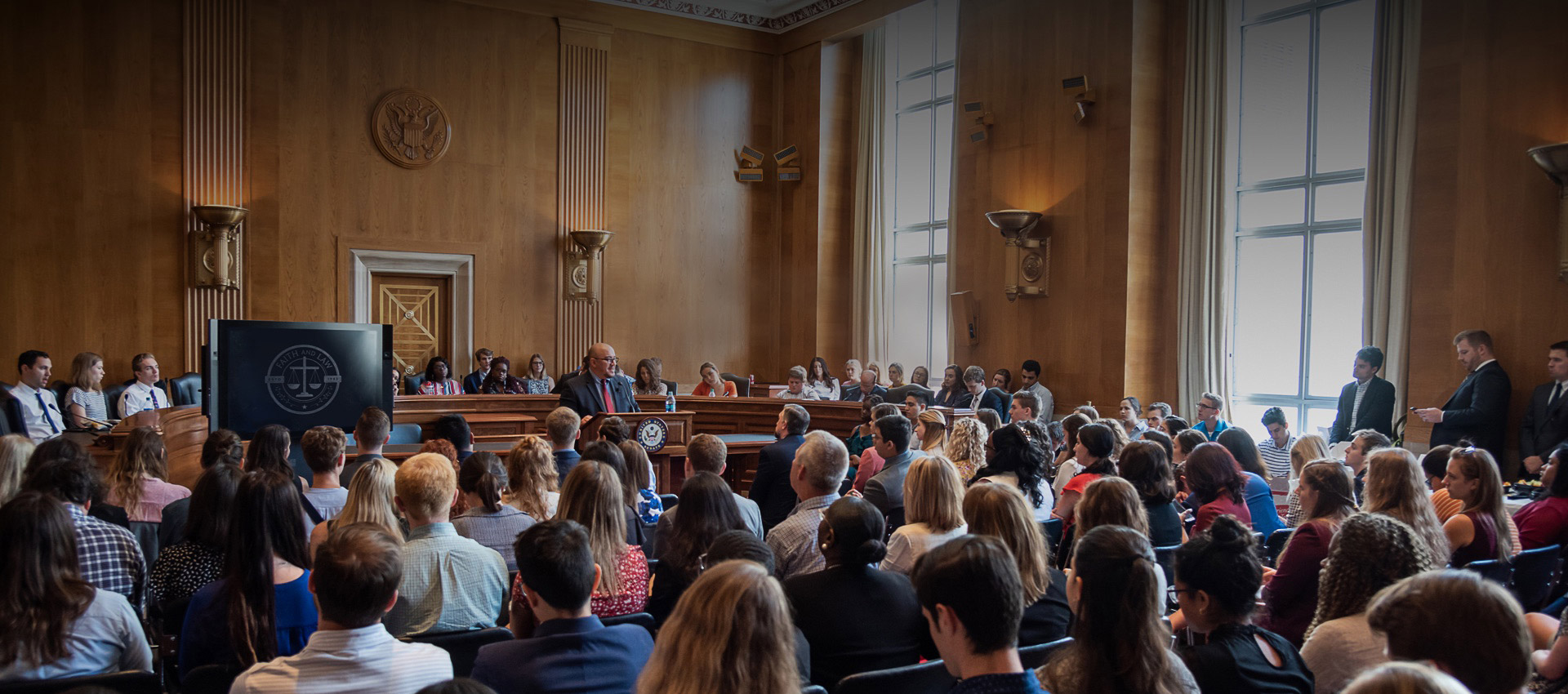 A large gathering for a Faith and Law event in a room in the US Capitol building.